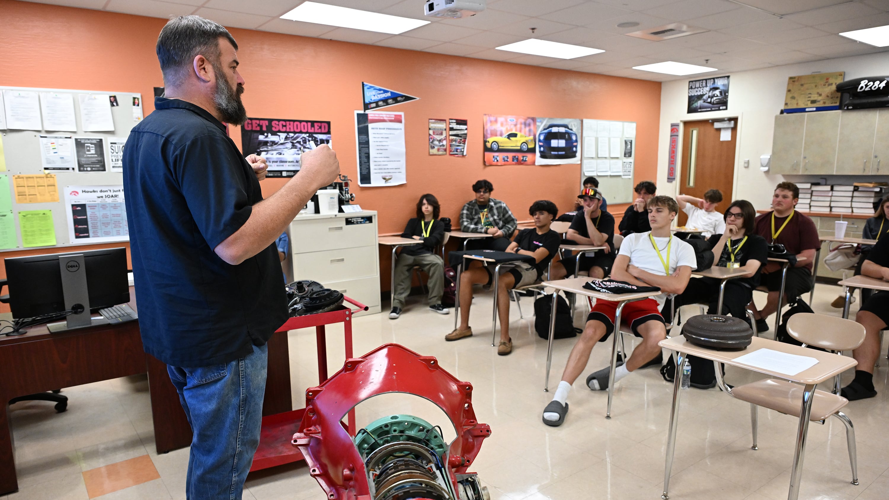 Instructor Michael Critchlow reviews for an ASE certification examine with senior class students at Seminole Ridge High School Automotive Academy.